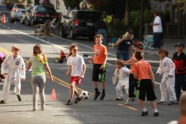 Kids playing soccer in the street